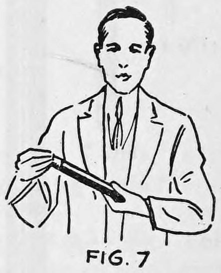 Fig. 7. — The same man pulling the large wand out of the left hand and holding it slanted across his body in the right hand.