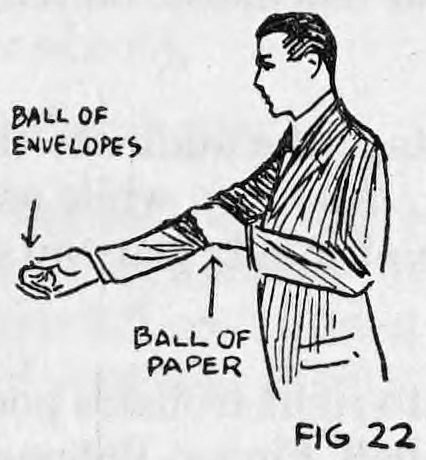 Fig. 22. — A man in a suit extending his right hand holding the ball of envelopes while the left hand grasps the right sleeve at the elbow, hiding the ball of paper.