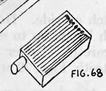 Fig. 68. — The prepared drawer with the cigarette lying in its partitioned channel, matches packed beside it, and the cigarette's end poking out through a hole in the end of the drawer.