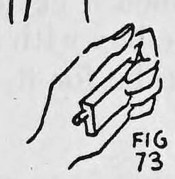 Fig. 73. — A close view of the hands holding the match box, with the cigarette sticking out of the end of the box toward the mouth.