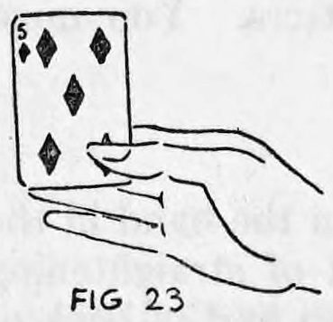 Fig. 23. — The produced card, five of diamonds, shown upright between thumb and first finger above the straightened hand.