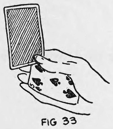 Fig. 33. — The card, shown with its back pattern, stands upright above the hand, pushed into position by the thumb while other cards stay palmed.