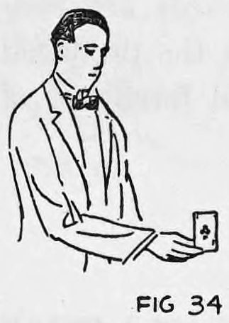 Fig. 34. — A man in a suit, seen from the side, holds out one card at his fingertips as it appears to the audience.