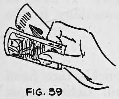 Fig. 39. — The right hand holds two cards even with each other, the position of the thumb shown, ready for back palming.