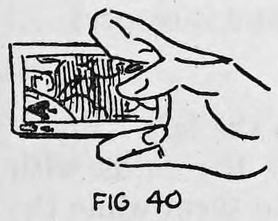 Fig. 40. — The fingers are curled inward as the two cards are brought together for back palming.