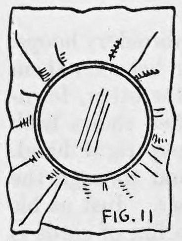 Fig. 11. — The finished tambourine: tissue paper crumpled around the outer hoop with the inner hoop pressed down over it, seen from above.