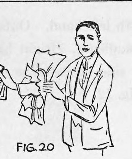 Fig. 20. — A man in a suit holds up his right hand, torn paper around the wrist, with a fan of cards spread at his finger tips.