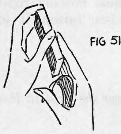 Fig. 51. — The right hand held up to the deck, fingers pointing at the center pip while the thumb still holds the palmed card.