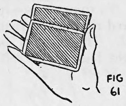 Fig. 61. — View away from the audience: the concealed card is pushed into the right hand, which holds the deck with its back showing.