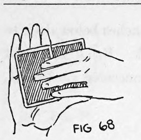 Fig. 68. — Rear view away from the audience: the right hand holds the deck with the concealed card palmed behind it, the left fingers below.