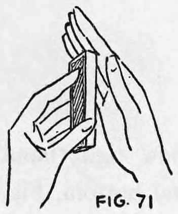 Fig. 71. — Cards and hands held horizontally, seen from above, with the rear card of the deck about to be pushed outward by the left forefinger.