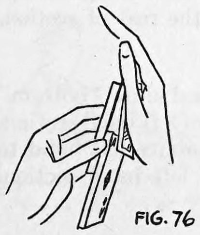 Fig. 76. — The right hand passes over the upper section of the deck, with two cards now palmed in it between thumb and little finger.