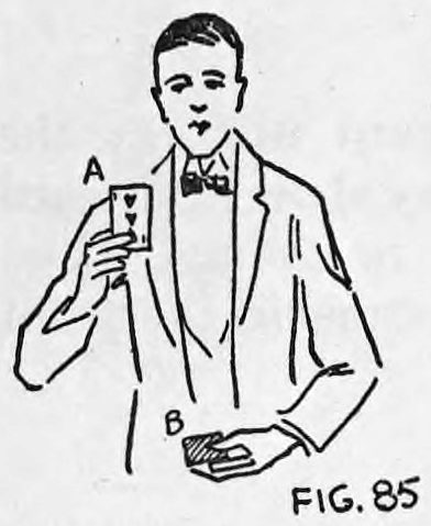 Fig. 85. — A performer in a bow tie looks straight at the audience, holding card A up in his right hand with card B in the left hand below.