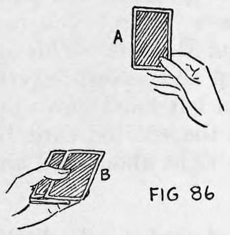 Fig. 86. — View away from the audience: card A held up between thumb and forefinger of the right hand, with card B pushed a little to the right on the deck.