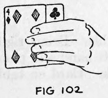 Fig. 102. — The cards as held towards the audience, with the thumb at the rear and the fingers in front of the deck, face cards showing.
