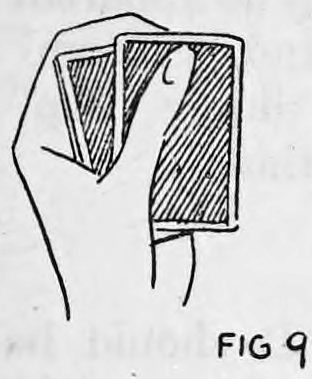 Fig. 93. — The left hand holding the deck with the top card moved over to the right by the thumb.