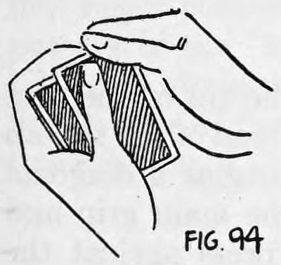 Fig. 94. — View from above: the right thumb at the corner of the top card and the right first finger under the bottom card of the deck held in the left hand.