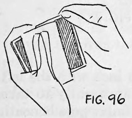 Fig. 96. — The right thumb and first finger pull the bottom card straight out of the deck while the left thumb draws the top card back onto it.