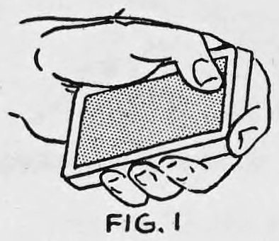 Fig. 1. — The left hand holds the deck face down in the Method 2 grip, seen from above, with the thumb on the top card.