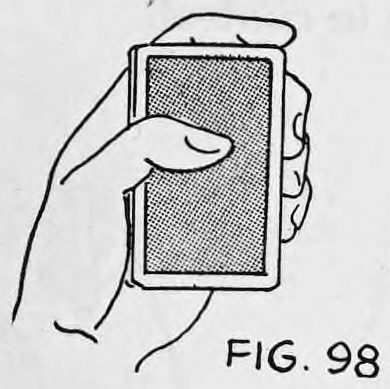 Fig. 98. — The left hand holds the deck face down, backs up, with the thumb lying on the top card and the fingers curled up the right side.