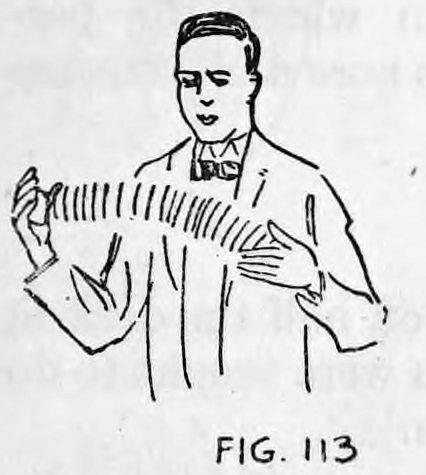 Fig. 113. — A man in a bow tie holds his hands wide apart, with a spread of cards forced horizontally from the right hand across to the left.