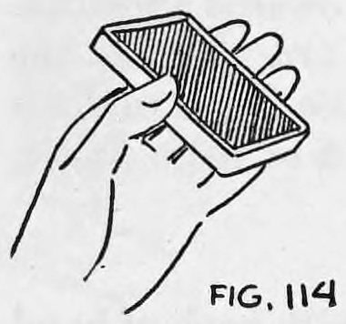 Fig. 114. — A hand holds the pack between fingers and thumb with the backs of the cards upward.