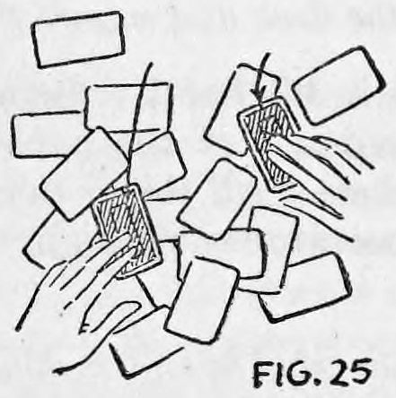 Fig. 25. — Cards scattered at all angles on the table, with the performer's right and left fingertips each resting on one of the two key cards while shuffling the rest around.