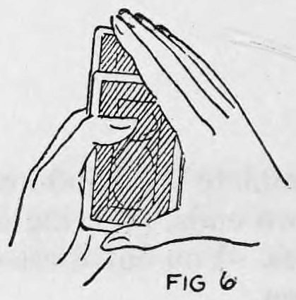 Fig. 6. — The right fingers push the selected card down into the deck held in the left hand, forcing the rubber band down around the card's lower edge.