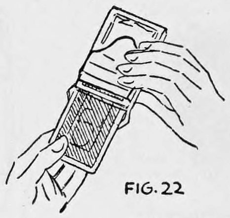 Fig. 22. — The right hand pulls the risen card out of the card case with the left hand from the back, the case held upright against the left forefinger.