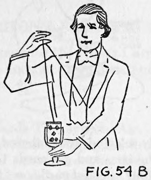 Fig. 54B. — Thurston in evening dress holds his raised right hand above a goblet containing a deck of cards while a thread runs from the goblet up to his fingers, a card rising.