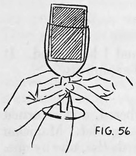 Fig. 56. — A glass holding a deck of cards, with the faces toward the audience, held by the stem in the left hand while the right hand removes the button from the stem.