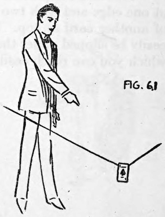 Fig. 61. — Thurston standing, his right hand pointing down toward the card, which hangs from a slanting thread stretched from the wings, sinking almost to the floor.