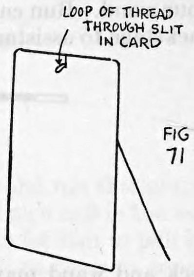 Fig. 71. — A card seen from the back with a half-inch loop of thread pushed through the top slit to the front; the thread runs down behind the card.