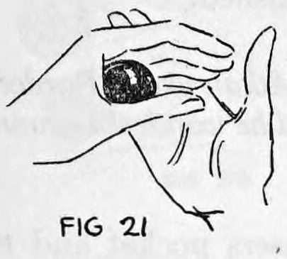 Fig. 21. — View away from the audience of the hands, the ball pushed into position between the left palm and thumb below the right hand.
