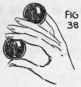 Fig. 38. — The right hand holding two balls, the left hand's ball placed between the third and fourth fingers below the shell ball.