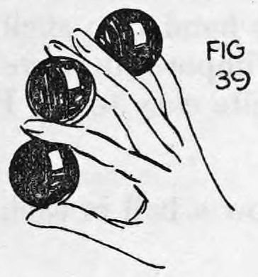 Fig. 39. — The right hand with three balls in a row, the second finger lifting the ball out of the shell into position between first and second fingers.