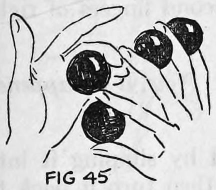 Fig. 45. — The left hand reaching over the right hand, which holds three balls, to take the ball from between its first and second fingers.