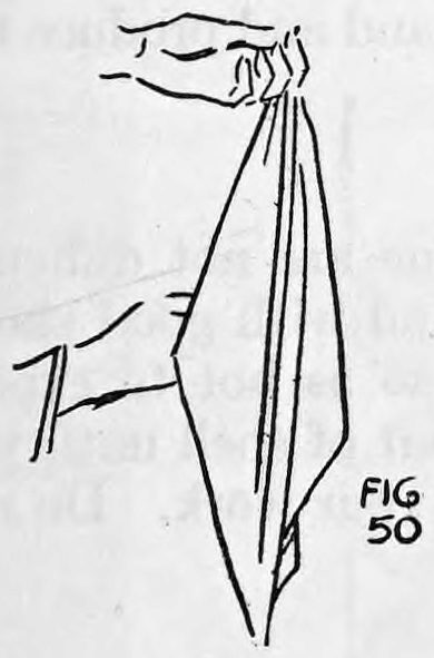 Fig. 50. — The silk hangs from the left hand while the right hand reaches behind the handkerchief to conceal the balls.