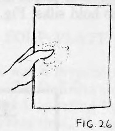 Fig. 26. — A left hand holds a newspaper upright, thumb in front and fingers behind, with dotted lines showing the silks hidden at the back.