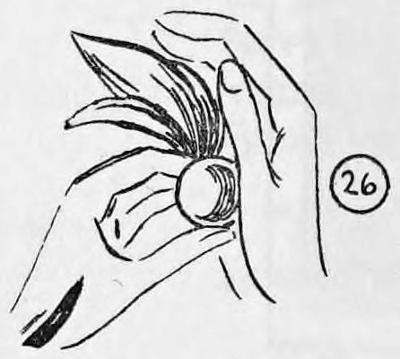 Fig. 26. — Right hand with the billiard ball palmed, the left fingers tucking the silk into the ball's opening, the back of the right hand toward the audience.