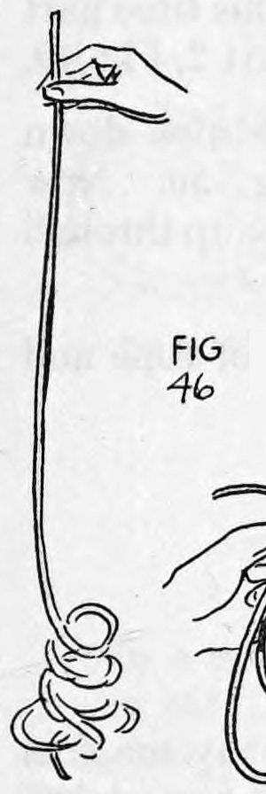 Fig. 46. — The rope hangs straight down from the left hand, the knots gone, with a small coil of rope lying at its lower end.