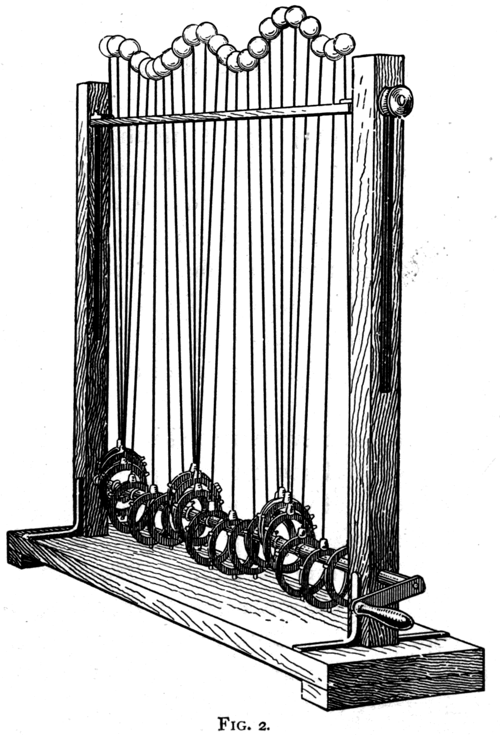 The wave-machine — a row of white balls on stems, each rising and falling in its own place, so that the shape of a travelling wave runs along a row of particles that never move sideways at all.