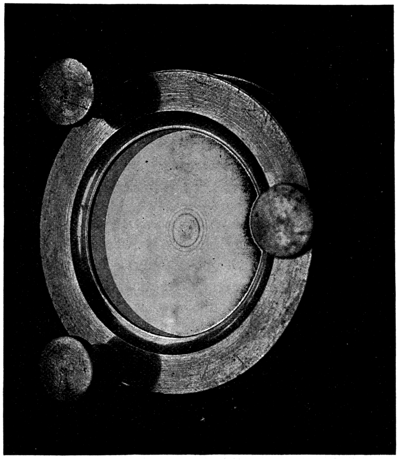 Newton's rings — the coloured circles produced by the film of air between a flat piece of glass and a very slightly curved one, with the black spot at the centre where the two touch.