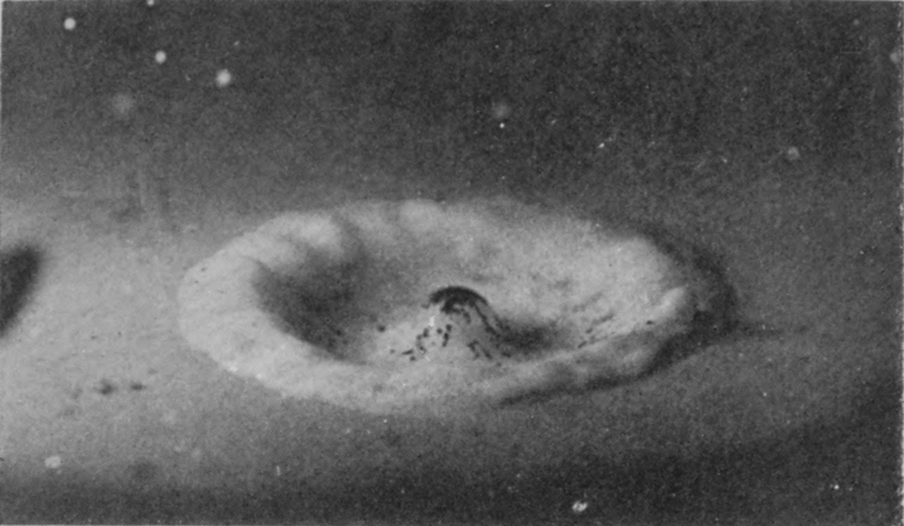 10 0·064 sec. — A broad, smooth ring surrounds a hollow in which a small mound, spotted with lamp-black, is beginning to rise at the centre.