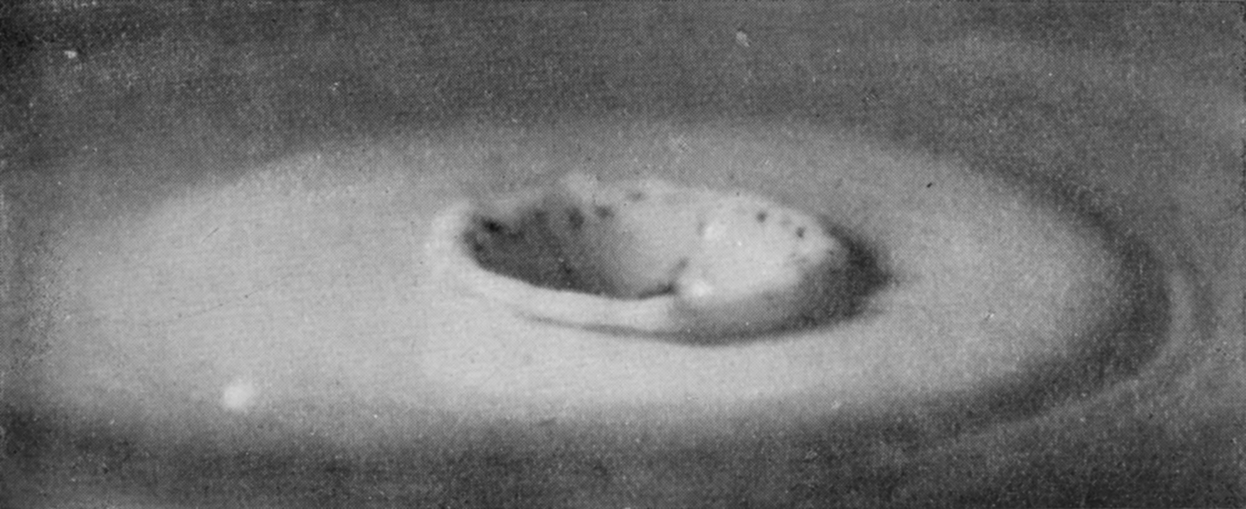 20 b 0·242 sec. — The secondary crater deeper and wider, with a smooth raised rim, and dark marks lying along its far inner wall.