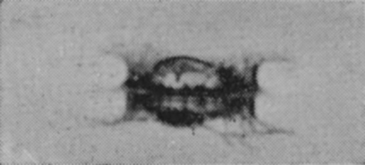 1 T = 0 — The drop has just gone in, and a low, dark crater with ragged edges stands on the surface, lit from behind and hard to make out.