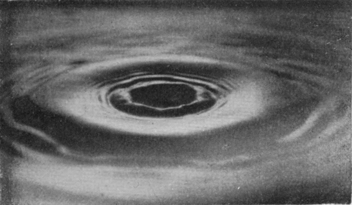 14 0·207 sec. — The column has gone down to a low dark dome at the centre of a bright hollow, with ripples spreading outward all round it.