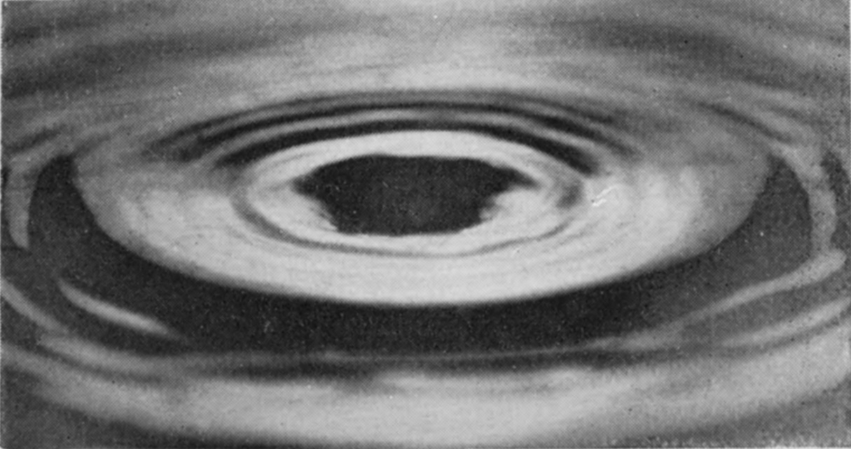 15 0·227 sec. — Nothing now stands above the surface: a dark, many-sided patch lies at the centre where the column went down, ringed by close concentric ripples.