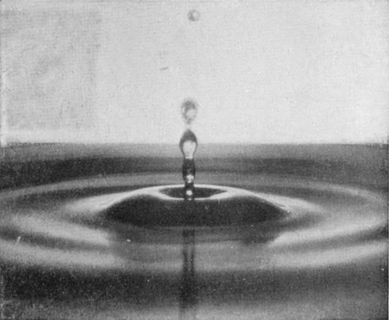 21 0·321 sec. — The central depression has deepened round the foot of a narrow column that is breaking into drops, with a separated droplet high above.