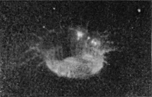 2 a — The drop has punched a sheer-walled pit, and milk streams up its sides in fine lines that spread into a fringe of thin jets above the rim.